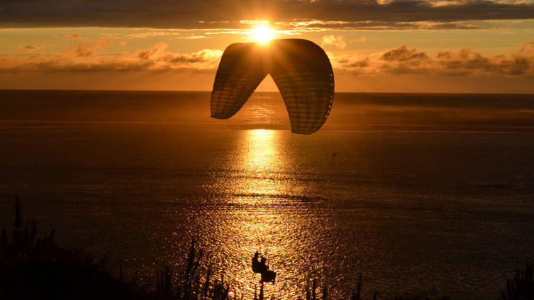 Sunset paragliding flight